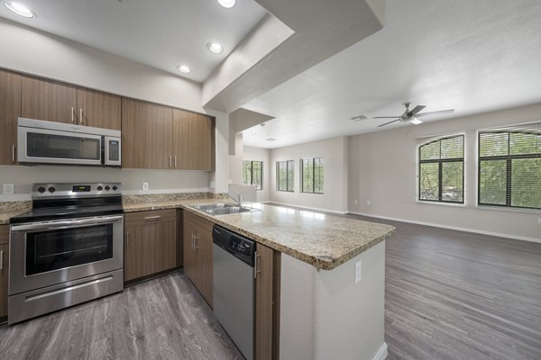 Contemporary kitchen with stainless steel appliances at Indigo Apartments