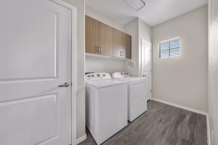 Laundry room featuring modern appliances at Indigo Apartments, a Greystar luxury community