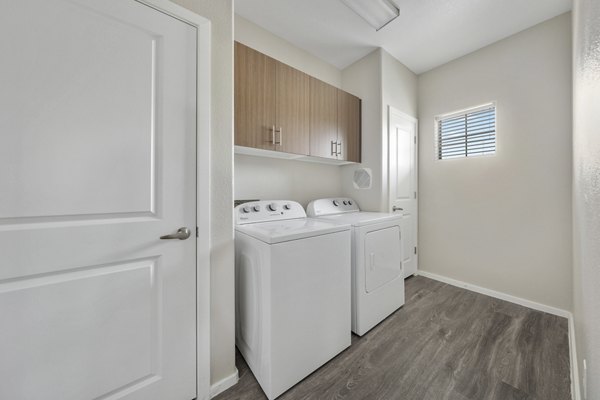 Laundry room featuring modern appliances at Indigo Apartments, a Greystar luxury community