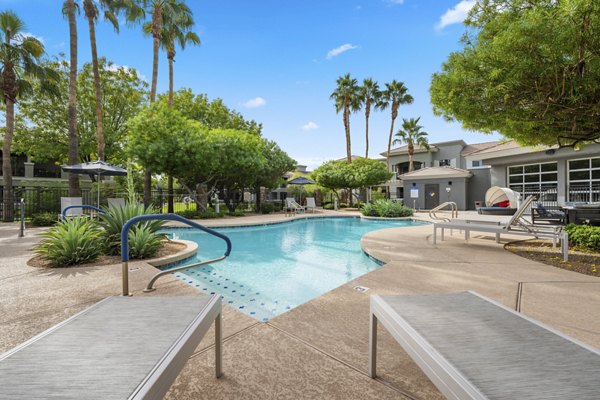 Resort-style pool with lounge seating at Indigo Apartments