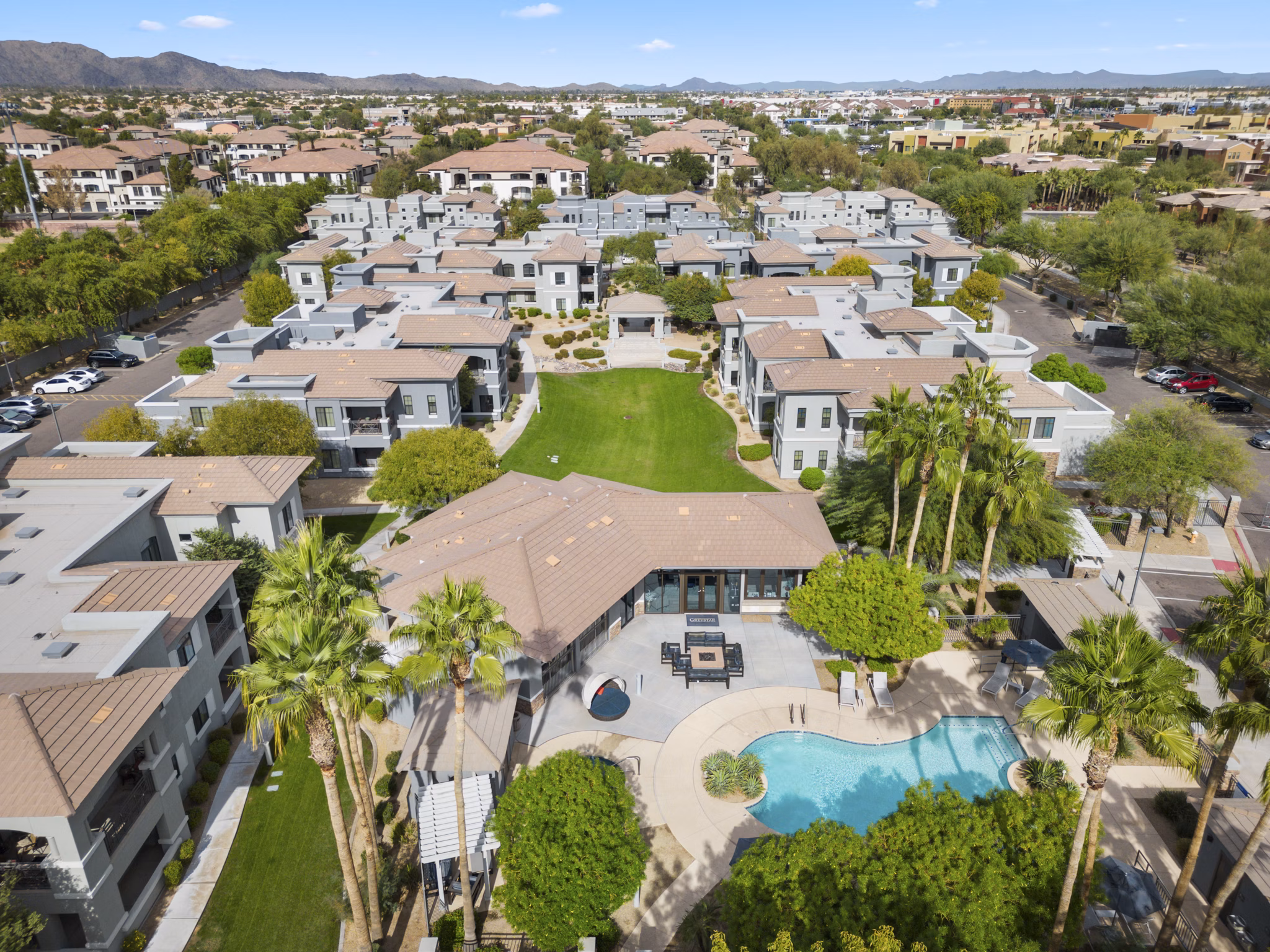 View of Indigo Apartments: Luxury high-rise with city skyline backdrop in downtown Phoenix.