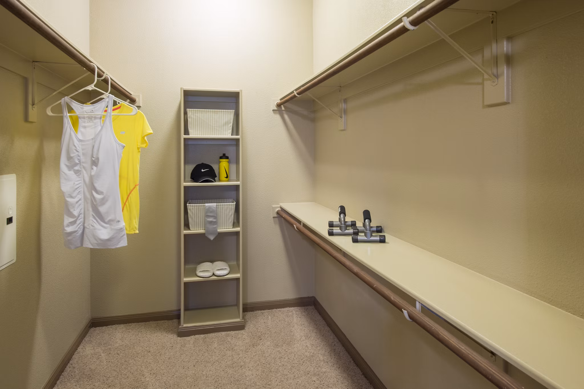 Montage at Cinco Ranch: Walk-in closet with custom shelving in luxury apartment