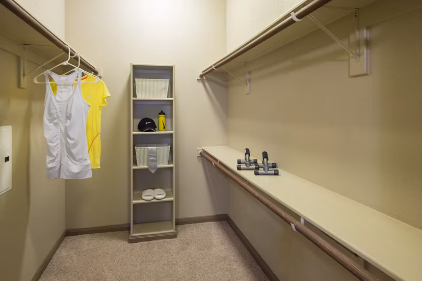 Montage at Cinco Ranch: Walk-in closet with custom shelving in luxury apartment