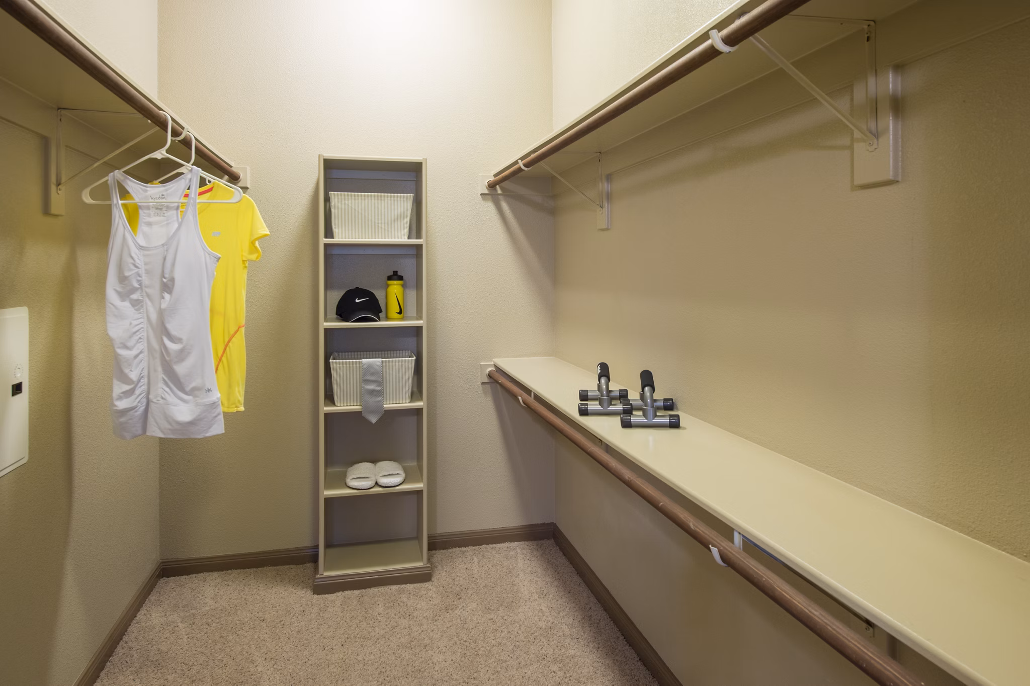 Montage at Cinco Ranch: Walk-in closet with custom shelving in luxury apartment