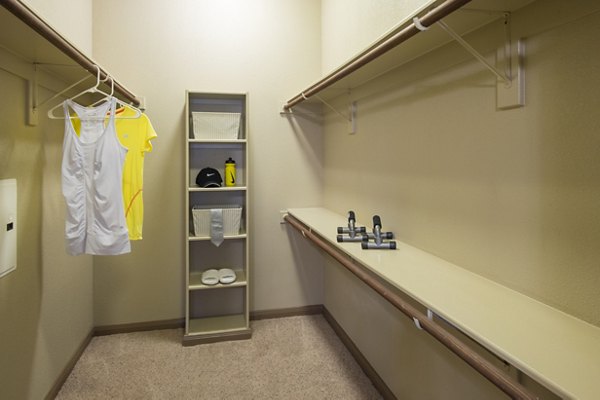 Montage at Cinco Ranch: Walk-in closet with custom shelving in luxury apartment
