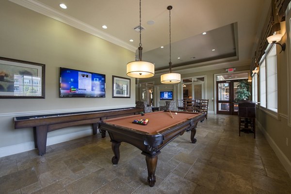 Game room with pool table and seating area at Montage at Cinco Ranch Apartments