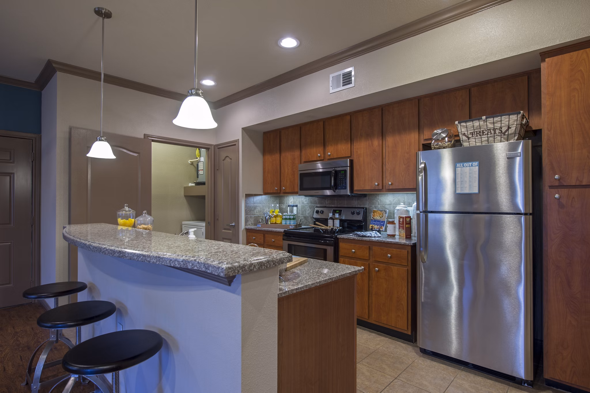 Modern kitchen with stainless steel appliances at Montage at Cinco Ranch Apartments