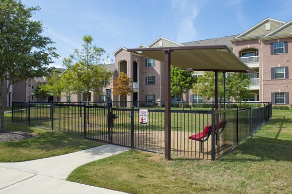 Spacious dog park with agility equipment at Montage at Cinco Ranch Apartments