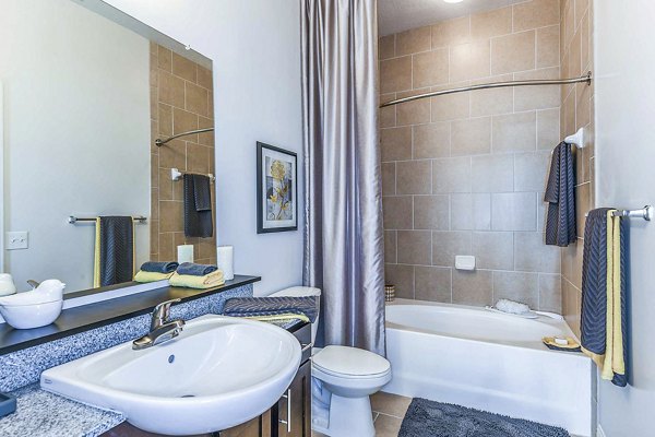 Modern bathroom with sleek fixtures at The Four Apartments, featuring marble countertops and spacious design