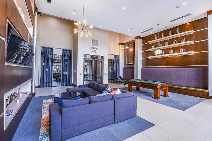 Elegant clubhouse with modern furnishings at The Four Apartments, featuring luxury amenities for residents in a welcoming social space