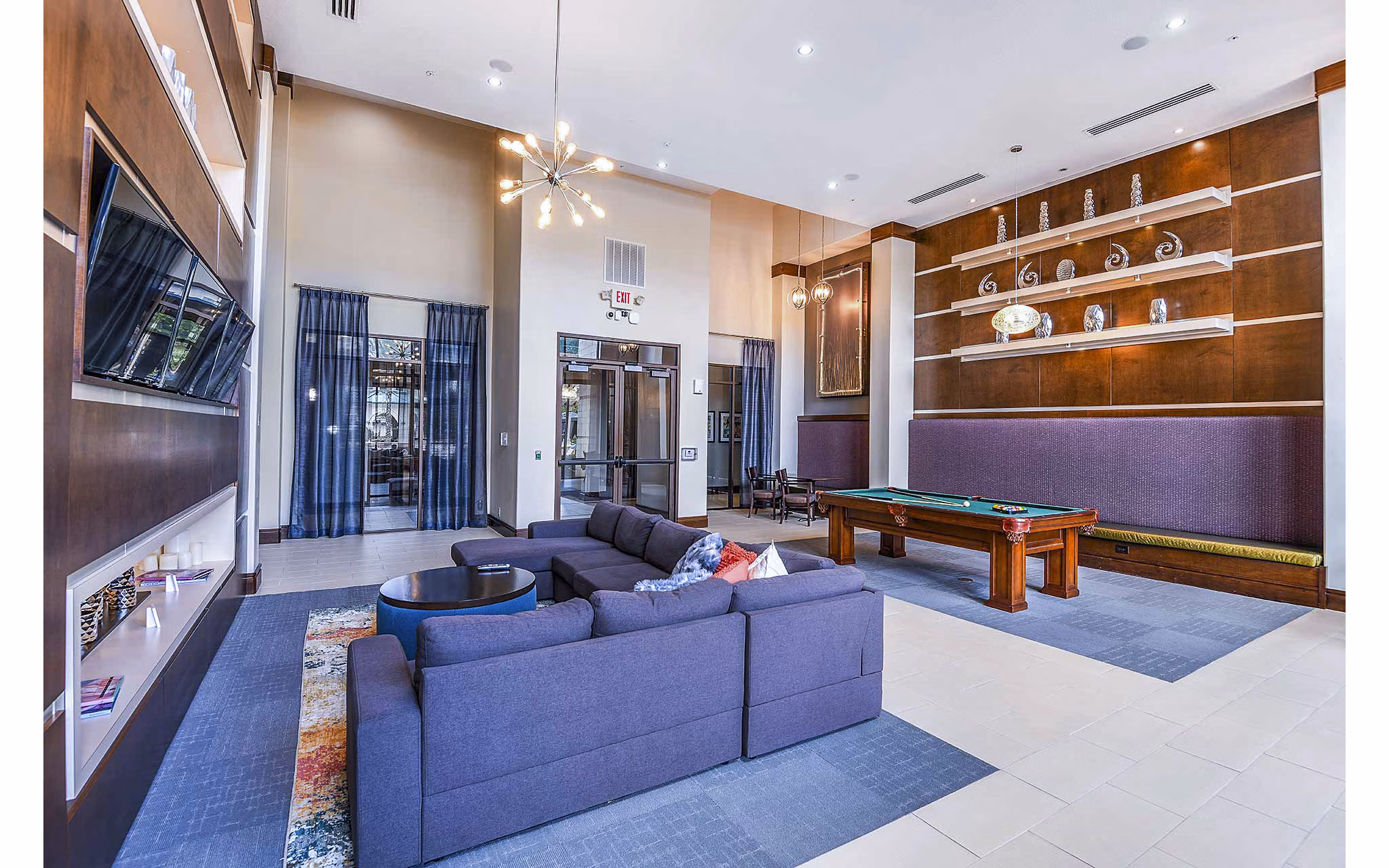 Elegant clubhouse with modern furnishings at The Four Apartments, featuring luxury amenities for residents in a welcoming social space