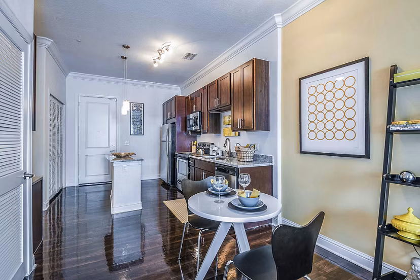 Dining room featuring elegant dÃ©cor and contemporary lighting in The Four Apartments, a luxury Greystar community