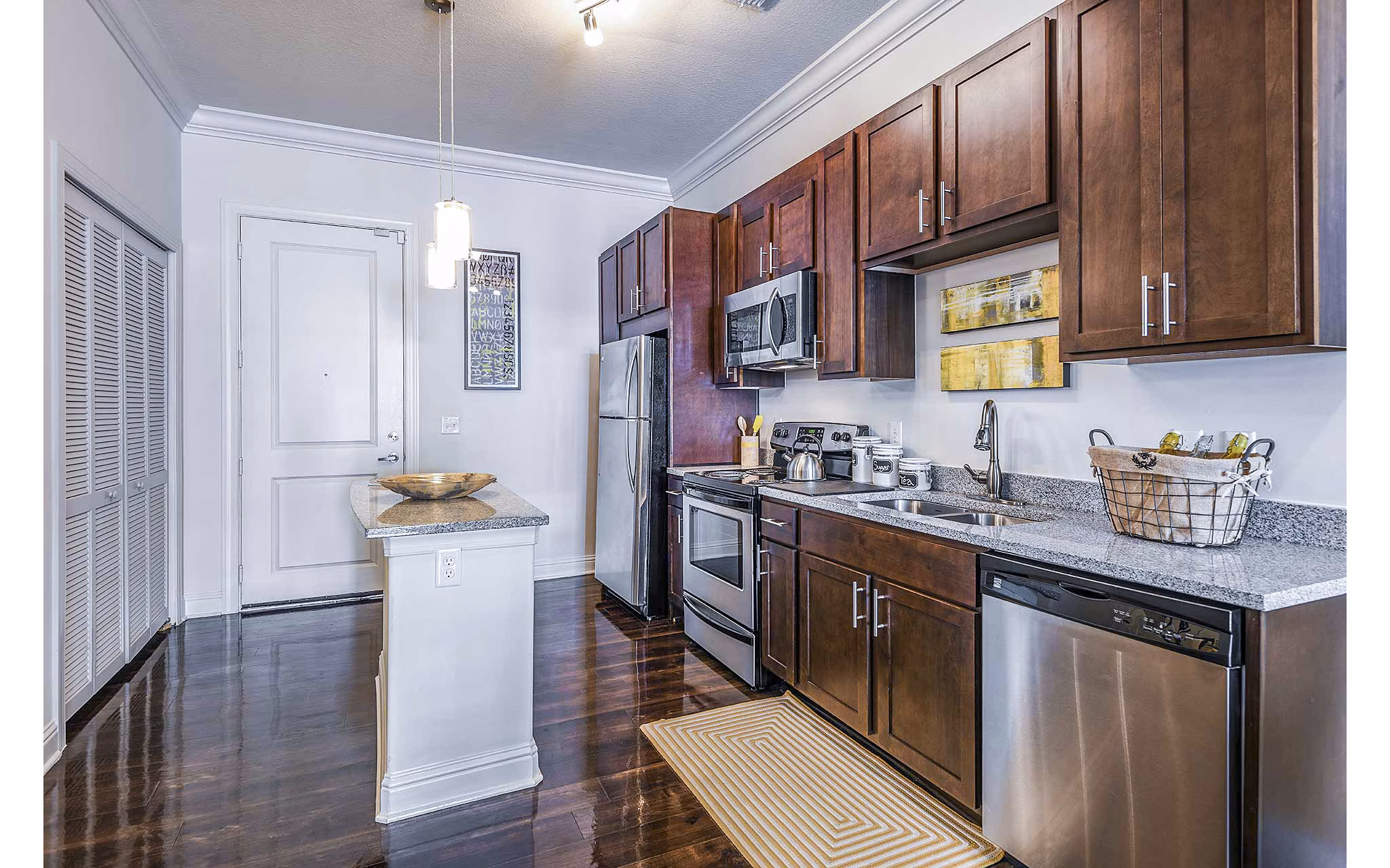 Modern kitchen with sleek countertops and stainless steel appliances at The Four Apartments in a Greystar luxury community