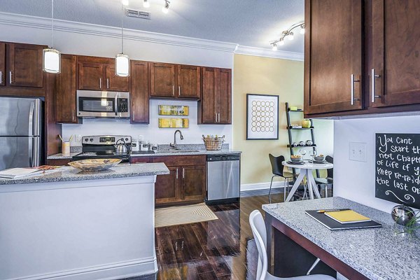 Modern kitchen with sleek countertops and home office space at The Four Apartments, ideal for luxury urban living and working from home