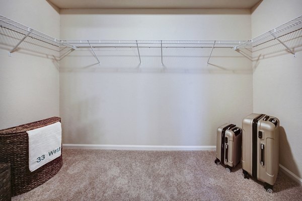 Custom closet space in a modern bedroom at 33 West Apartments, designed for convenience and ample storage solutions