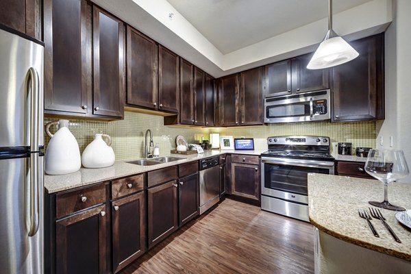 Modern kitchen with stainless steel appliances at 33 West Apartments