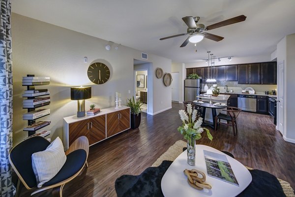 Spacious living room with modern furnishings and large windows at 33 West Apartments in a Greystar community