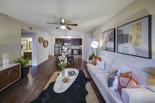Spacious living room with modern decor and large windows at 33 West Apartments