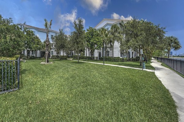Tranquil courtyard at 33 West Apartments featuring lush greenery and stylish seating for relaxation
