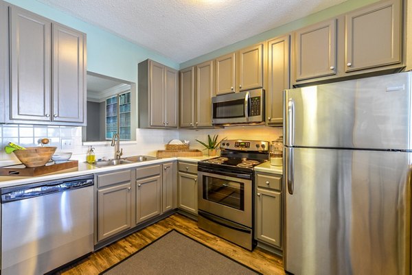 Modern kitchen with stainless steel appliances at Townhouse Atlanta apartments