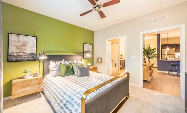 Element Carolina Bay Apartments: Modern bedroom with stylish decor and ample natural lighting