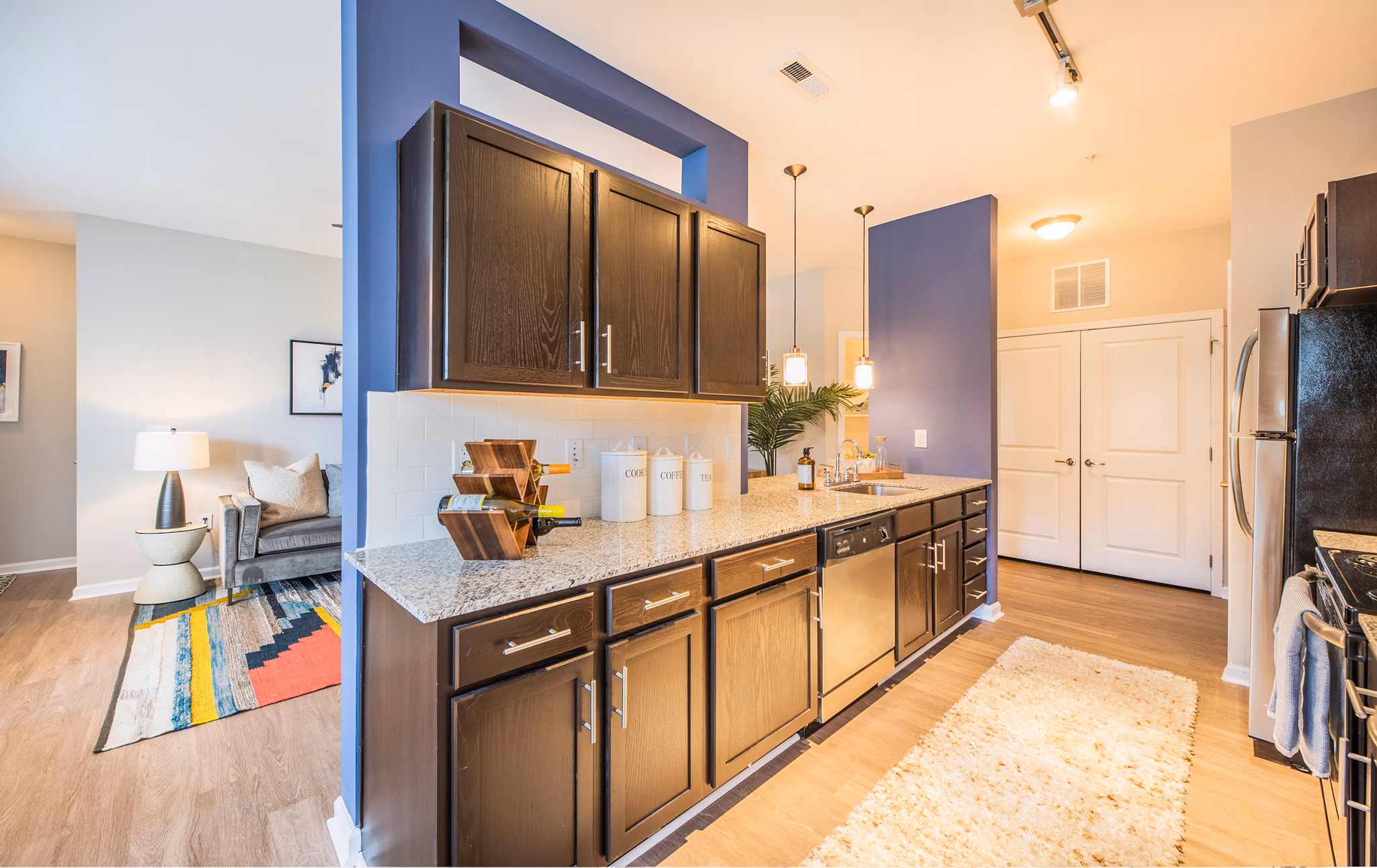 Element Carolina Bay Apartments: Modern clubhouse with vibrant seating and sleek decor in the luxurious Element Carolina Bay community