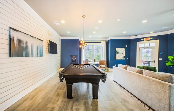 Clubhouse featuring modern seating and entertainment options at Element Carolina Bay Apartments, a Greystar luxury property in Charleston