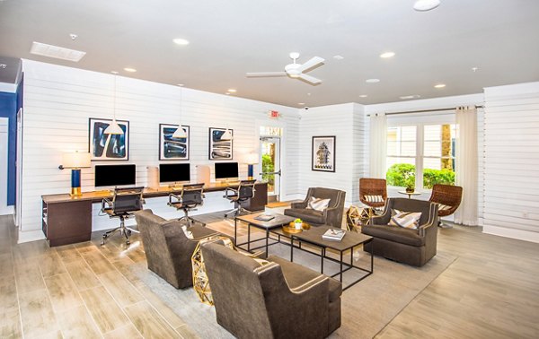 Business center with modern workstations at Element Carolina Bay Apartments, ideal for remote work and collaborative meetings