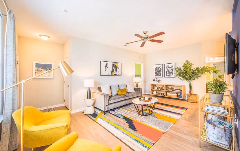 Spacious living room with modern furniture and bright lighting at Element Carolina Bay Apartments