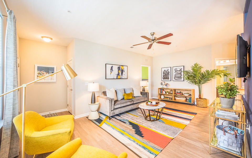Spacious living room with modern furniture and bright lighting at Element Carolina Bay Apartments
