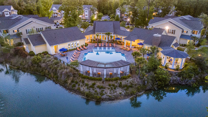 Element Carolina Bay Apartments: Scenic view of luxury apartments surrounded by lush greenery in Charleston