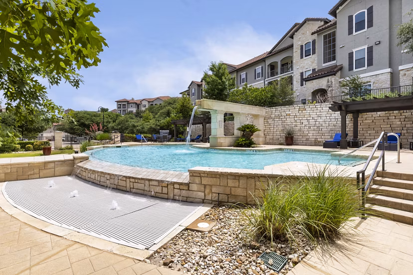 Resort-style pool with lounge seating at 3500 Westlake Apartments