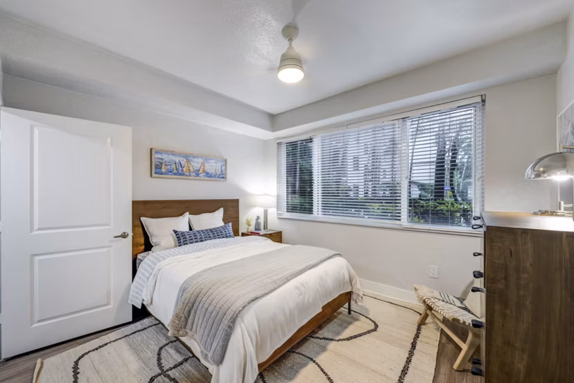 Cozy bedroom featuring modern decor and large windows in Solmar on 6th luxury apartments