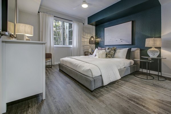 Cozy bedroom featuring modern decor and large windows in Solmar on 6th luxury apartments
