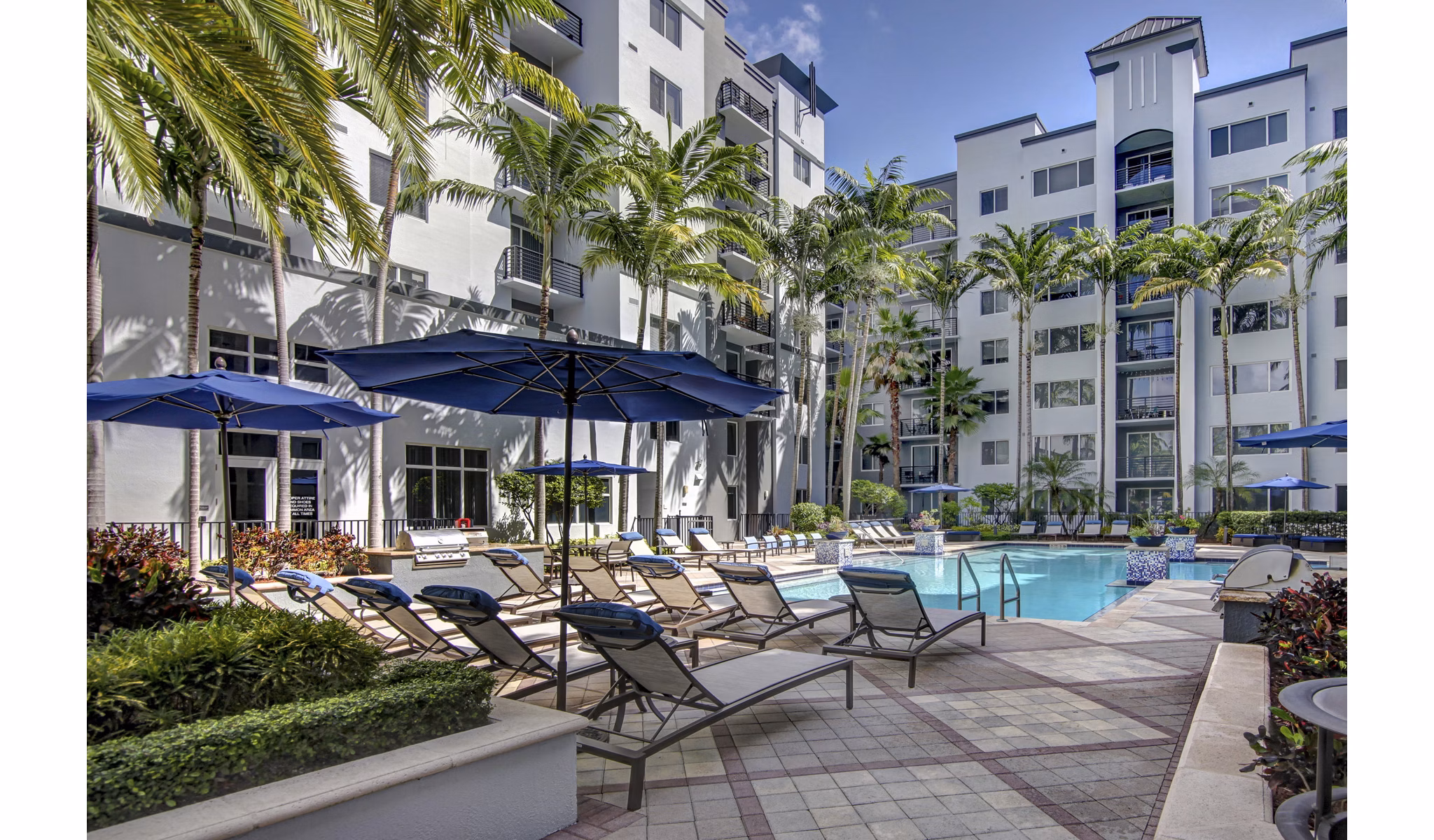 Inviting pool at Solmar on 6th luxury apartments, featuring poolside loungers and city views