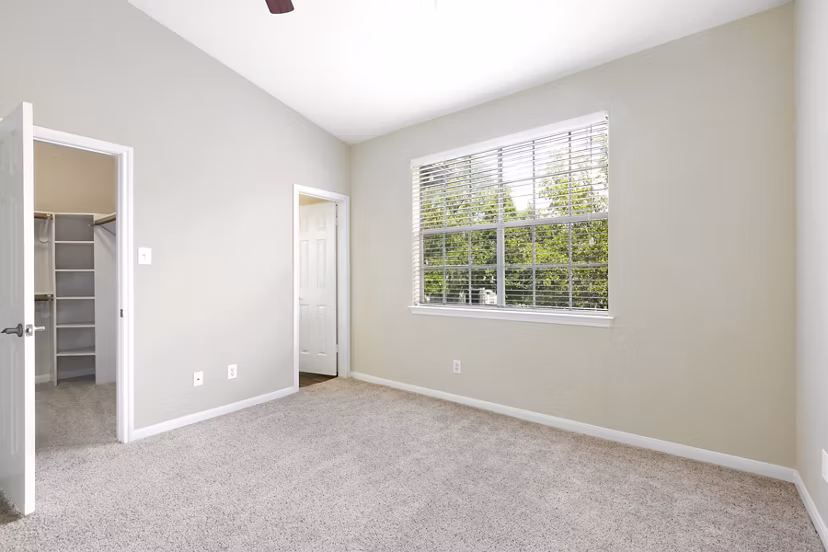 Cozy bedroom with modern decor at The Boulevard at Town Lake Apartments, featuring plush bedding and stylish accent pieces