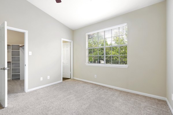 Cozy bedroom with modern decor at The Boulevard at Town Lake Apartments, featuring plush bedding and stylish accent pieces