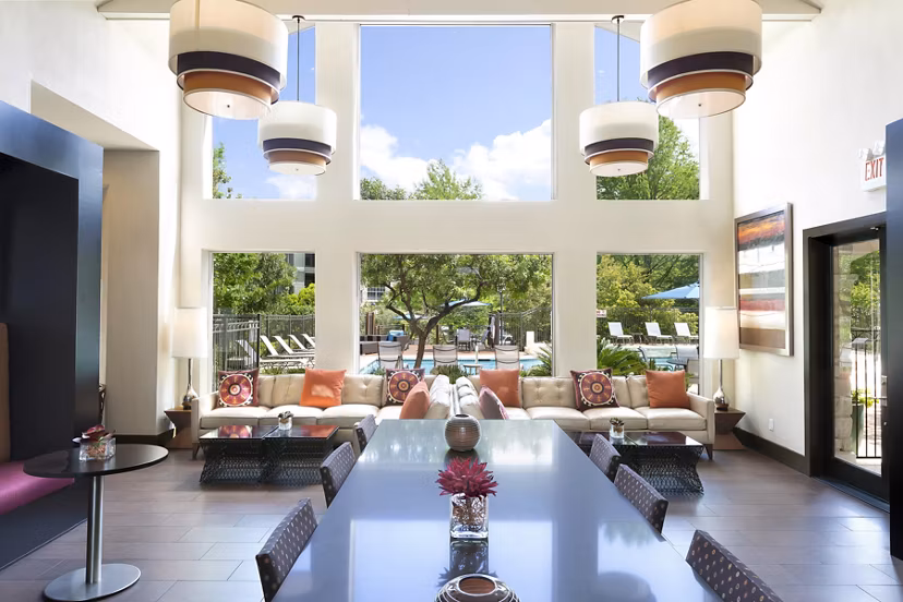 Clubhouse with modern dÃ©cor and lounge seating at The Boulevard at Town Lake Apartments, a Greystar luxury apartment community