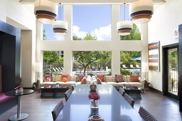 Clubhouse with modern dÃ©cor and lounge seating at The Boulevard at Town Lake Apartments, a Greystar luxury apartment community