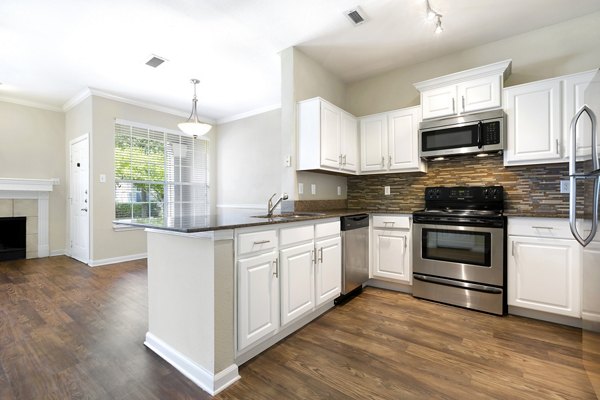 Modern kitchen with stainless steel appliances at The Boulevard at Town Lake Apartments Ideal for luxurious living in a Greystar community