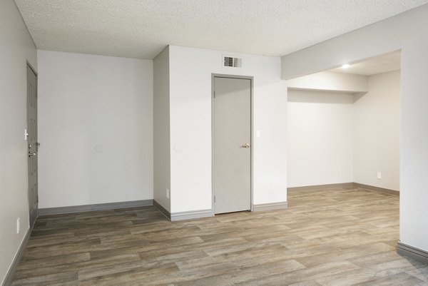 Elegant dining area with hardwood floors at Highland Park Apartments, a luxury Greystar community