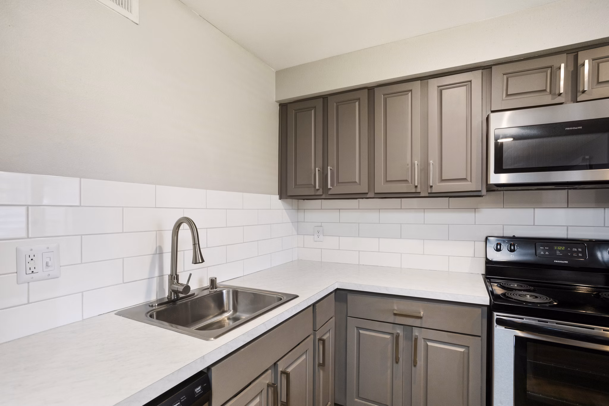 Modern kitchen with stainless steel appliances in Highland Park Apartments luxury apartments