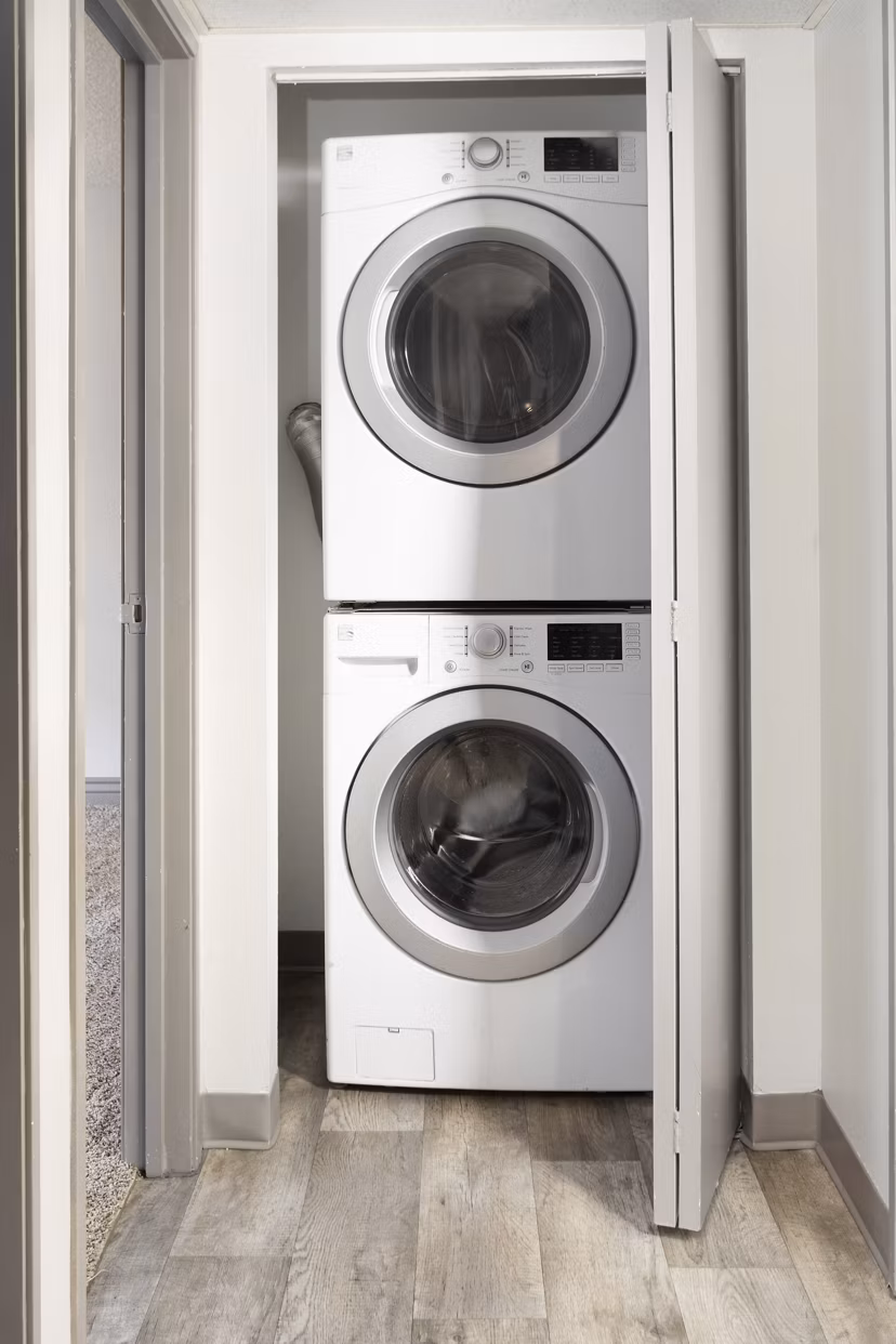 Laundry room with modern washers and dryers at Highland Park Apartments, a Greystar luxury community