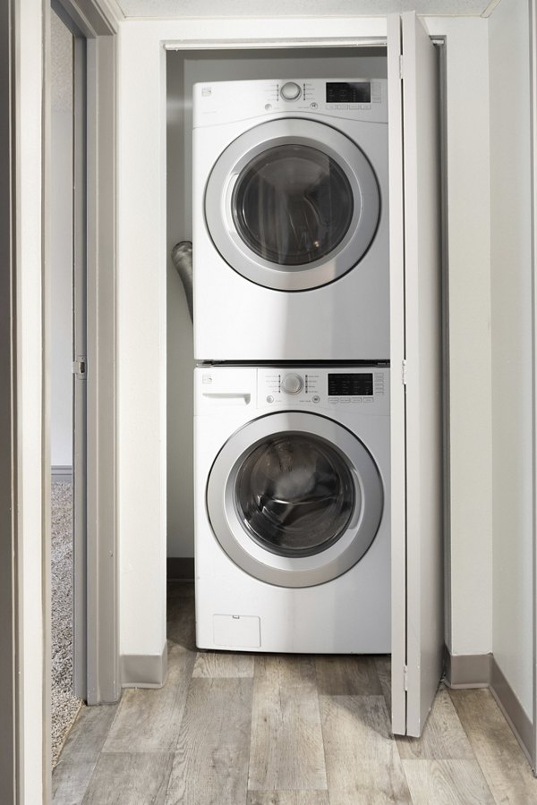 Laundry room with modern washers and dryers at Highland Park Apartments, a Greystar luxury community