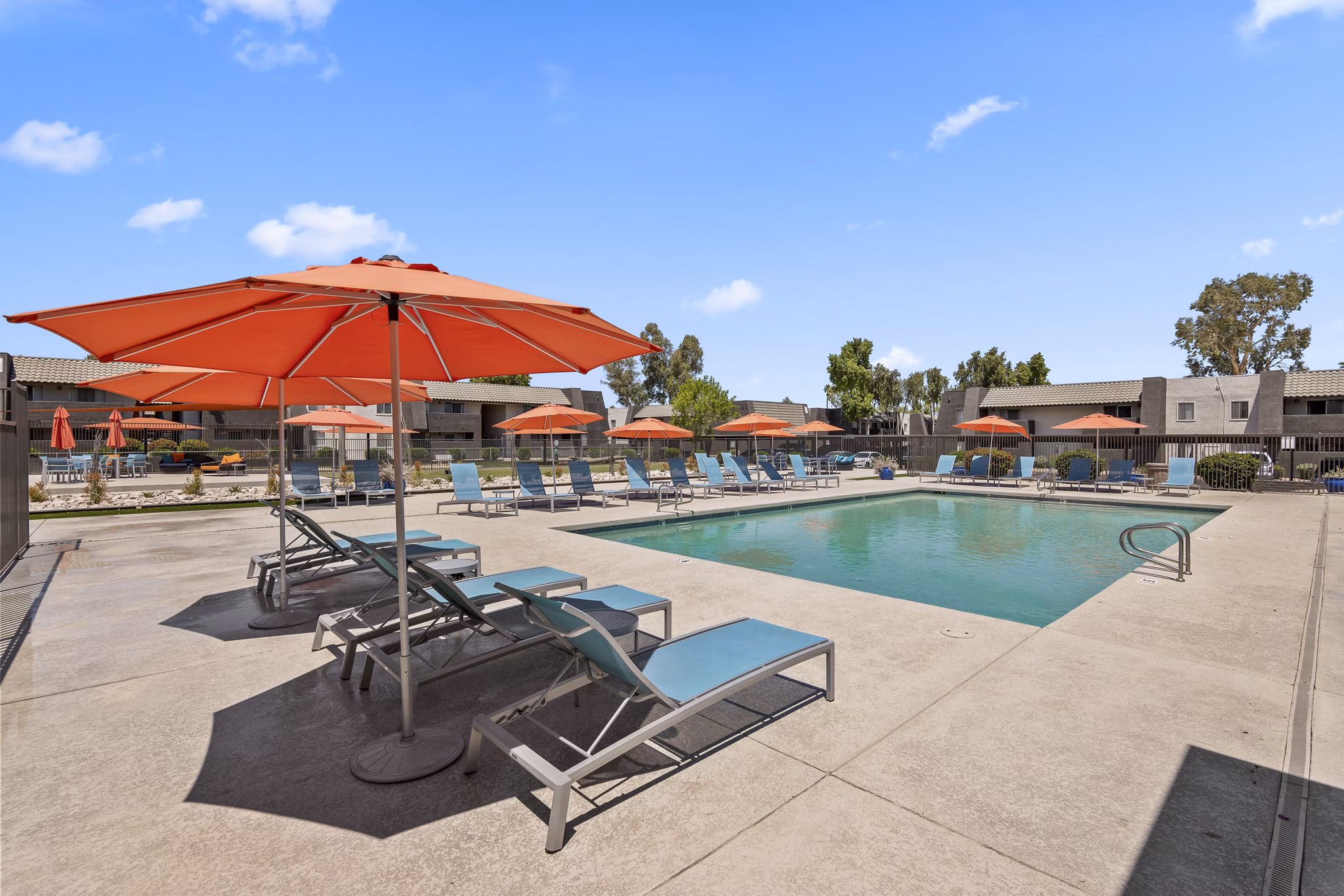 Resort-style pool with lounge chairs at Highland Park Apartments, a Greystar luxury community