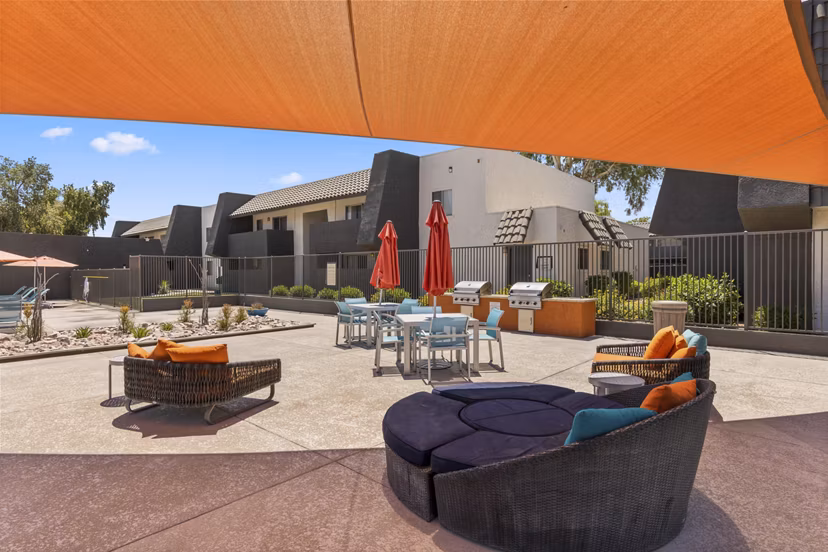 Spacious grill patio with modern seating at Highland Park Apartments, perfect for outdoor gatherings