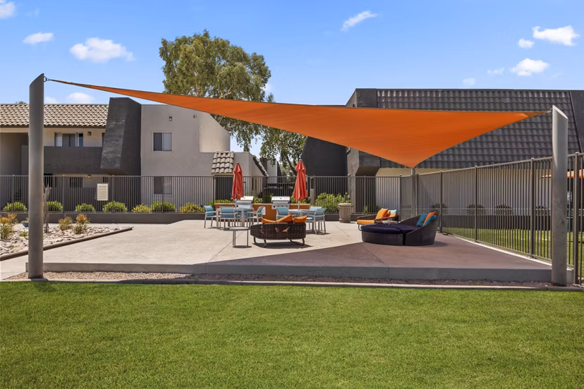 Outdoor grill area and patio at Highland Park Apartments offering a space for leisure and dining