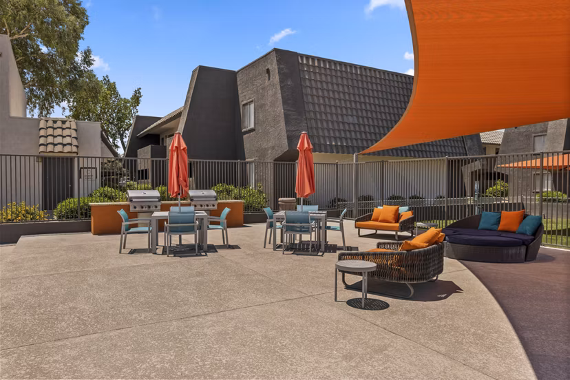 Outdoor grill area with modern seating at Highland Park Apartments