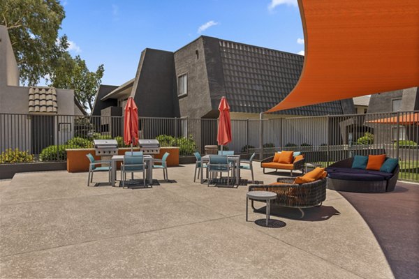Outdoor grill area with modern seating at Highland Park Apartments
