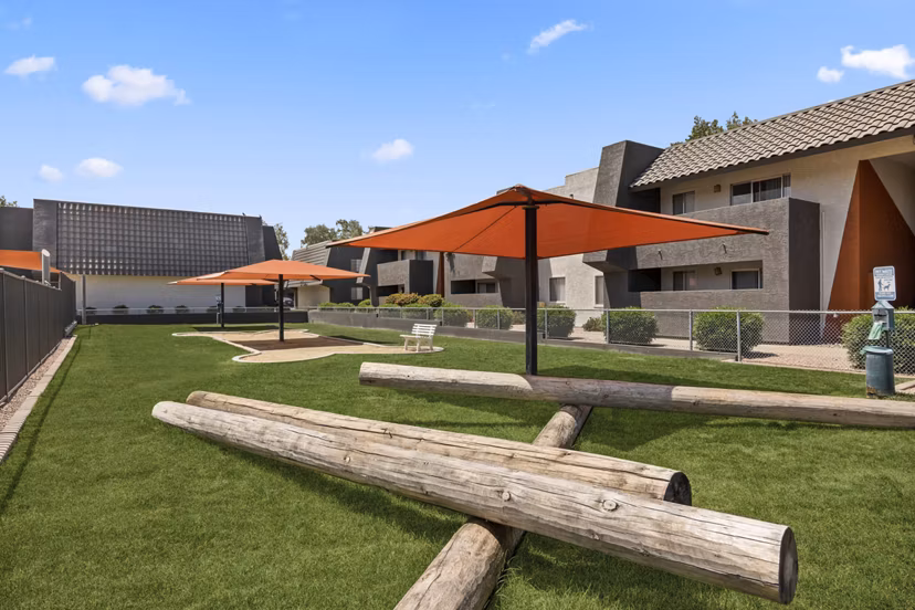 Outdoor recreational area featuring lush greenery at Highland Park Apartments